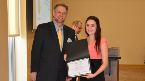 Sarah Lilly is presented the Hill Award from Dean Spencer Niles