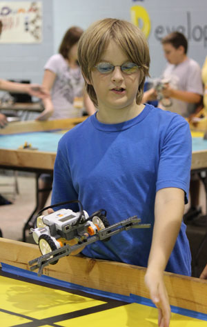 A student demonstrates the robot he built at the 2011 Dahlgren summer academy at Naval Surface Warfare Center Dahlgren Division. Photo Credit: Jake Joseph