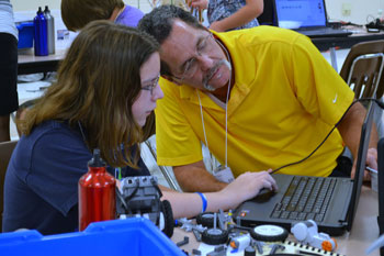 A student and a STEM professional collaborate on a project during the First Annual Hampton Roads STEM Summer Academy  at Corporate Landing Middle School in Virginia Beach. Photo Credit: Karen Hogue