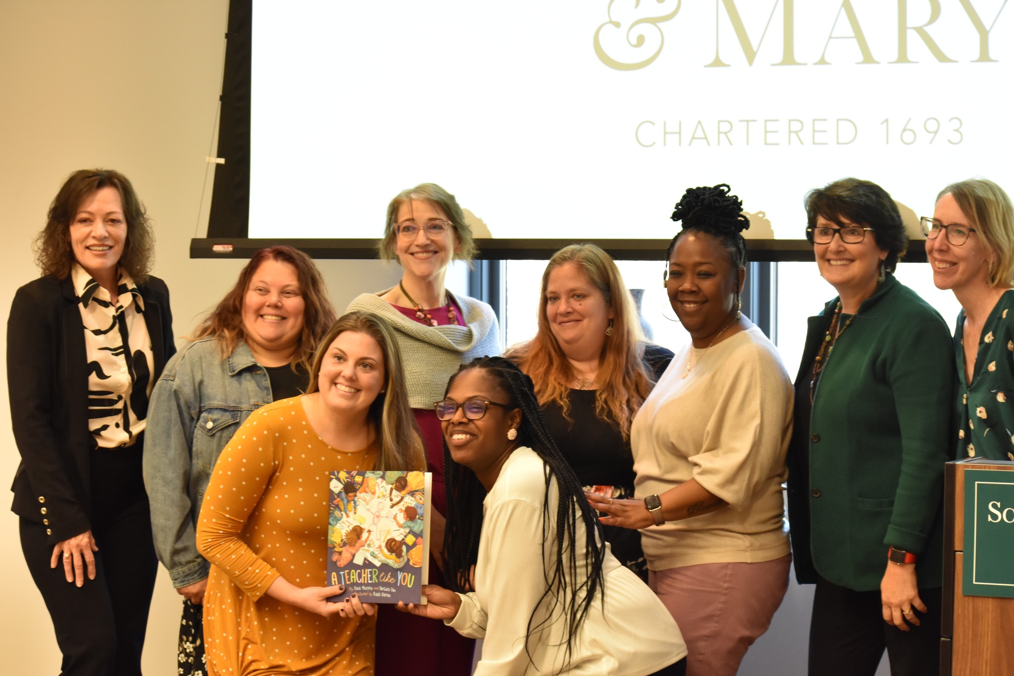 Denise Johnson (left), Kristin Conradi Smith (far right), and Tamara Williams (second from right) join a small group of the cohort for a picture.