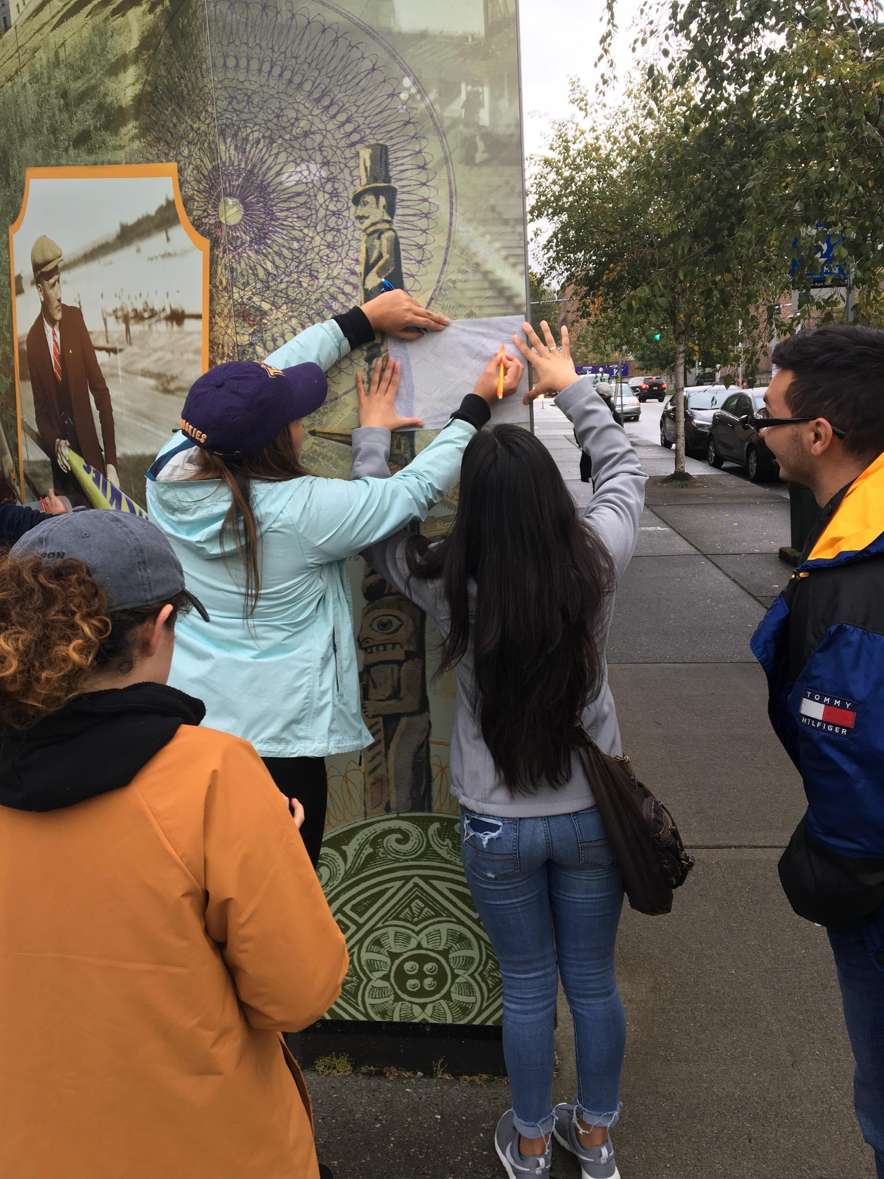 University of Washington students moving between city spaces and digital maps to learn about the role of BIPOC residents in Seattle's development through a curriculum called Mobile City Science. Photo Credit: UW Katie Headrick Taylor.