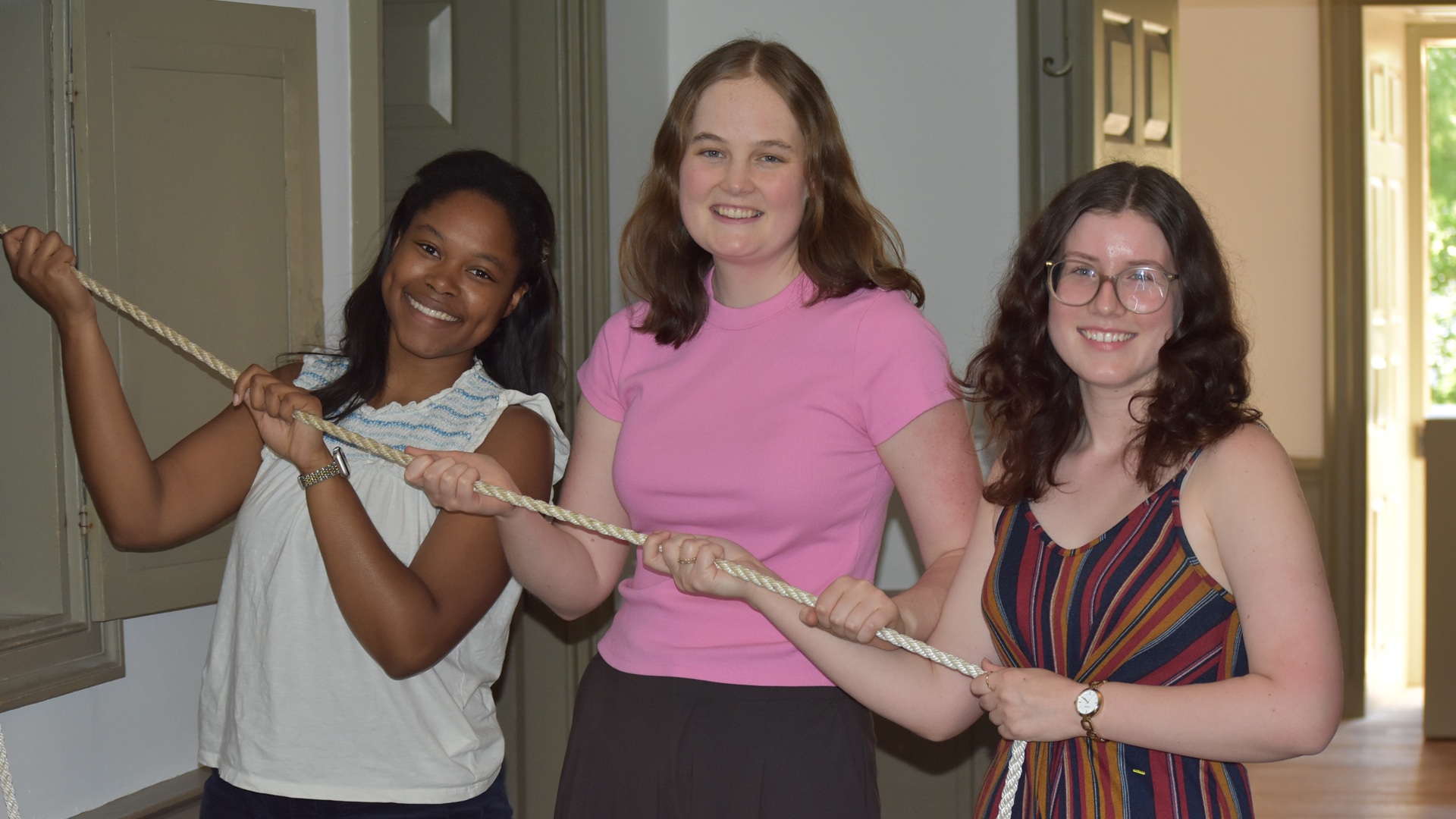 Graduate students ringing the Wren Bell on W&M Historic Campus