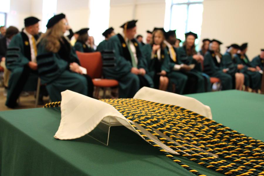 Doctoral cords displayed on table