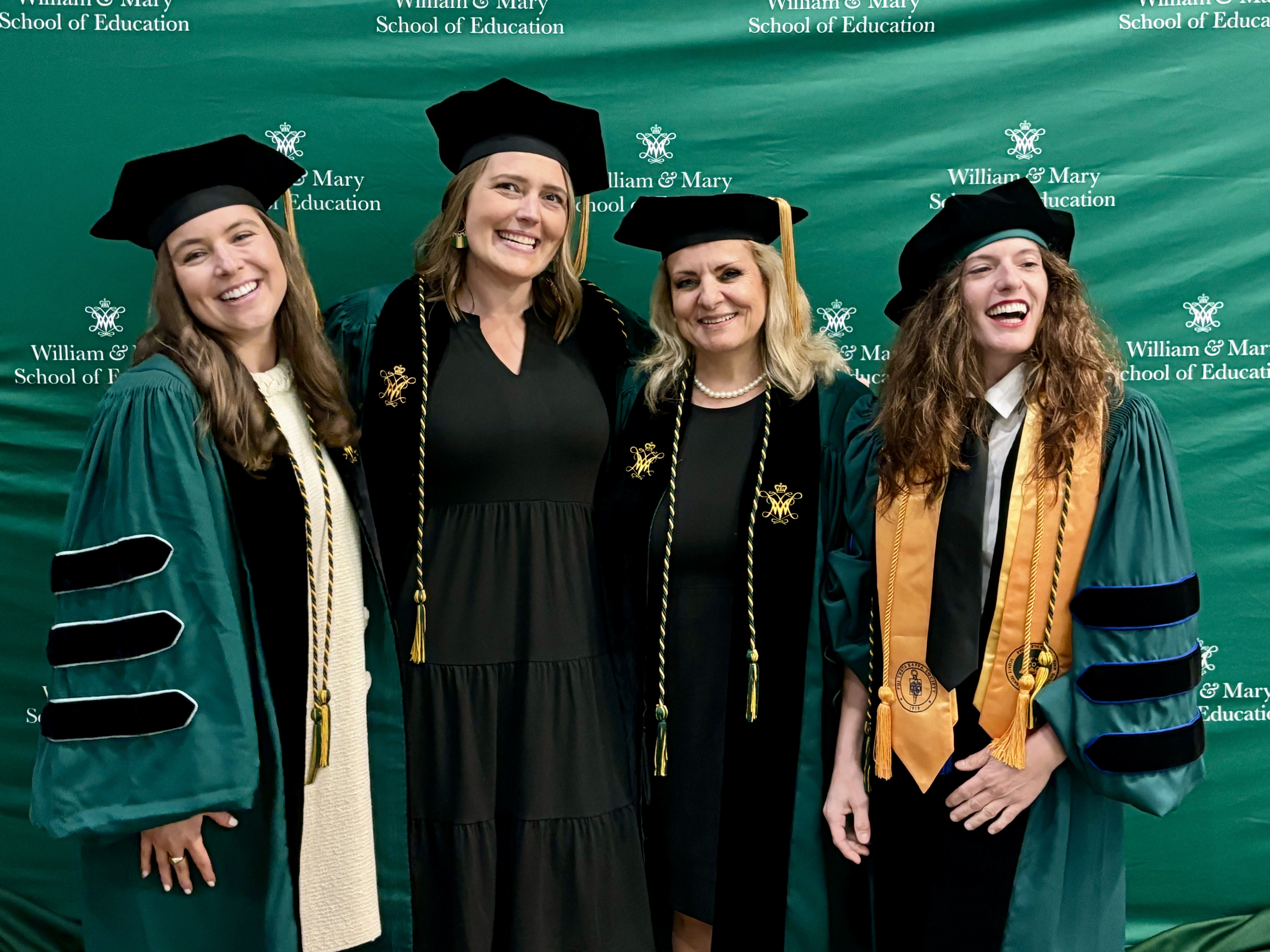 4 doctoral student in full graduation regalia