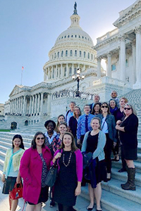 Pamela Eddy and students pose on the steps of the Capitol Building.