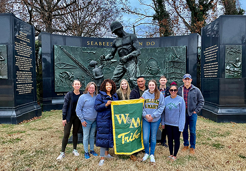 The group gathers for a photo at the Seabee Memorial.