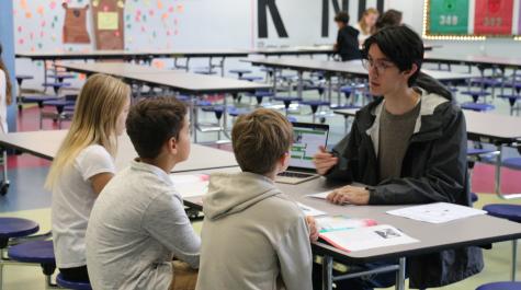 School of Education student working with fifth graders at Clara Byrd Baker Elementary School.