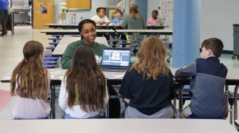 School of Education student working with fifth graders at Clara Byrd Baker Elementary School.