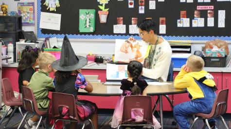 School of Education student working with kindergarteners at Clara Byrd Baker Elementary School.