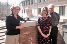Amy Colley, assistant superintendent for curriculum and instruction at Poquoson City Public Schools, poses for a photo after ringing the bell at the School of Education with her dissertation committee chair Michael DiPaola and committee member Leslie Grant. Doctoral students ring the bell after succesfully defending their dissertations.